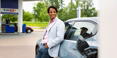 Man leaning against car Tango electric